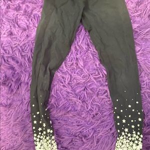 Black leggings with white starts on the ankles.